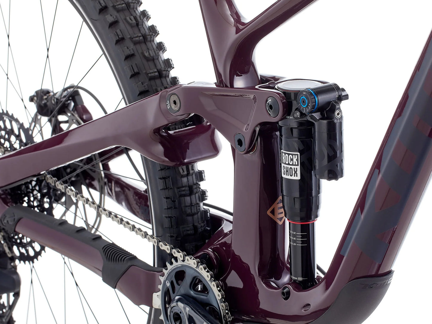 Close-up of a bicycle's suspension fork and chain on a white background