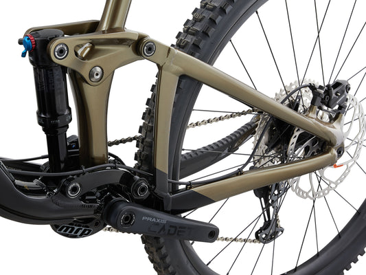 Close-up of a mountain bike's suspension fork and chain mechanism on a white background