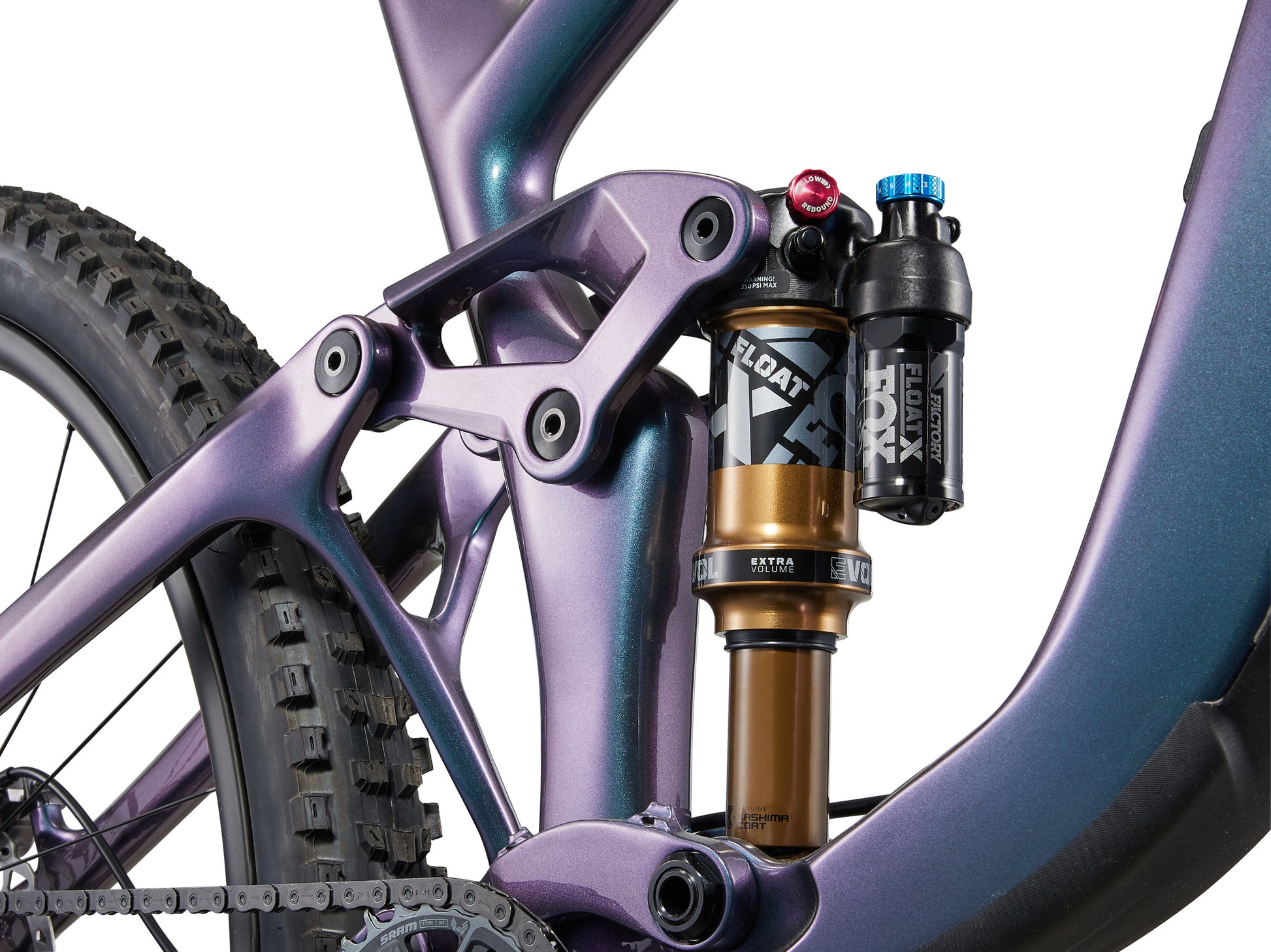 Close-up of a purple mountain bike with suspension fork and shock absorber on a white background