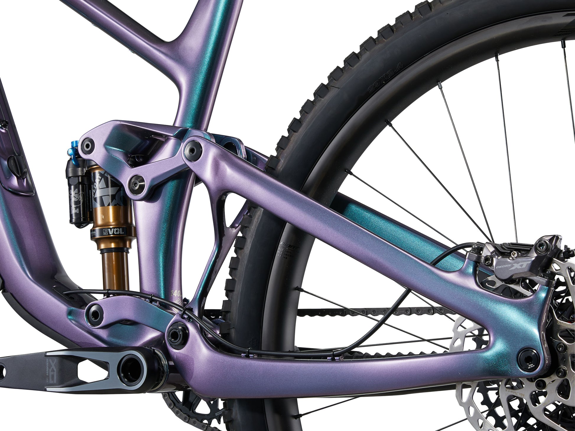 Close-up of a purple and teal mountain bike frame with suspension fork.