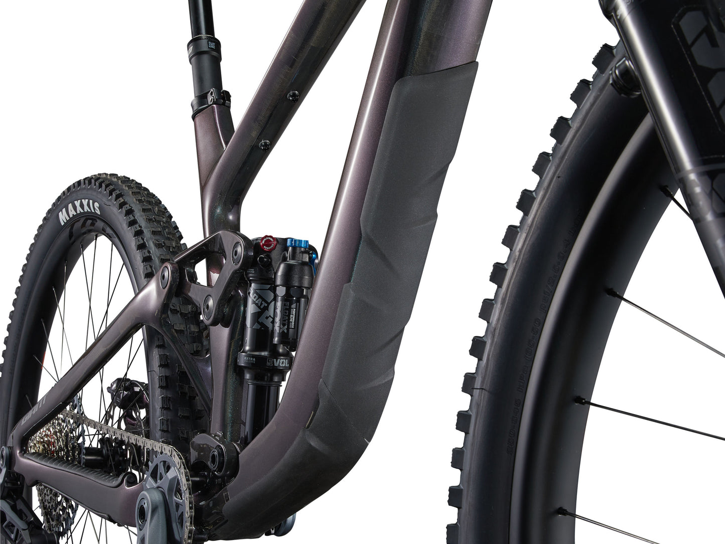 Close-up of a mountain bike with focus on the suspension fork and tire tread.