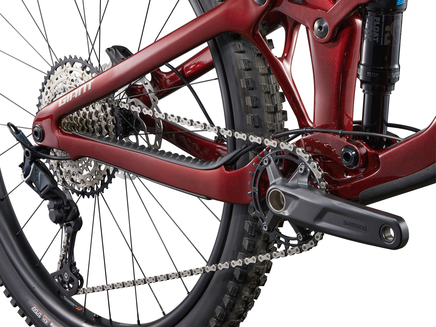 Close-up of a red bicycle chain and gear system on a white background
