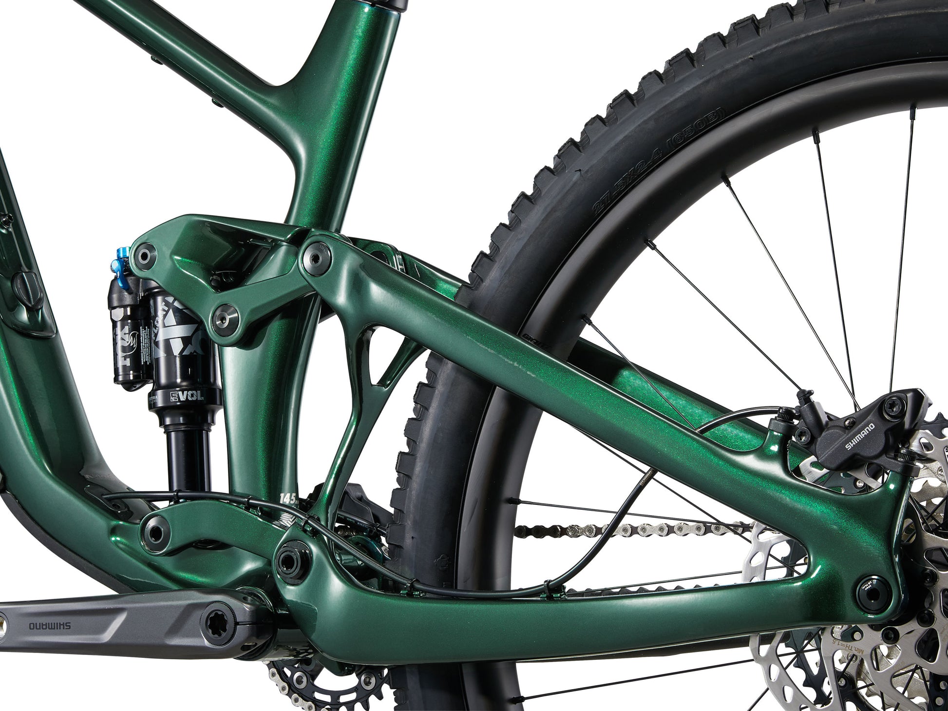 Close-up of a green mountain bike frame and wheel on a white background
