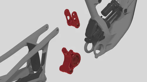 Motorcycle suspension components with red mounting hardware on a gray background