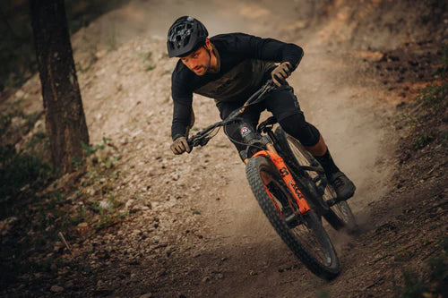 Person riding a mountain bike on a dirt trail