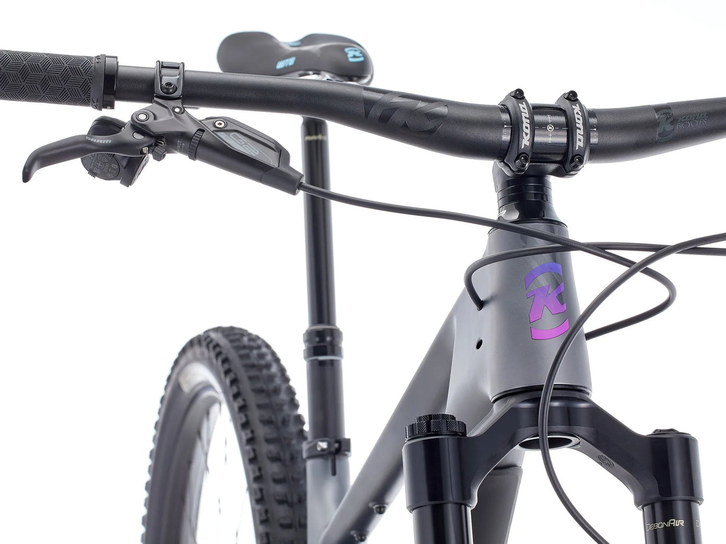 Close-up of a bicycle handlebar with visible brand logo on a white background