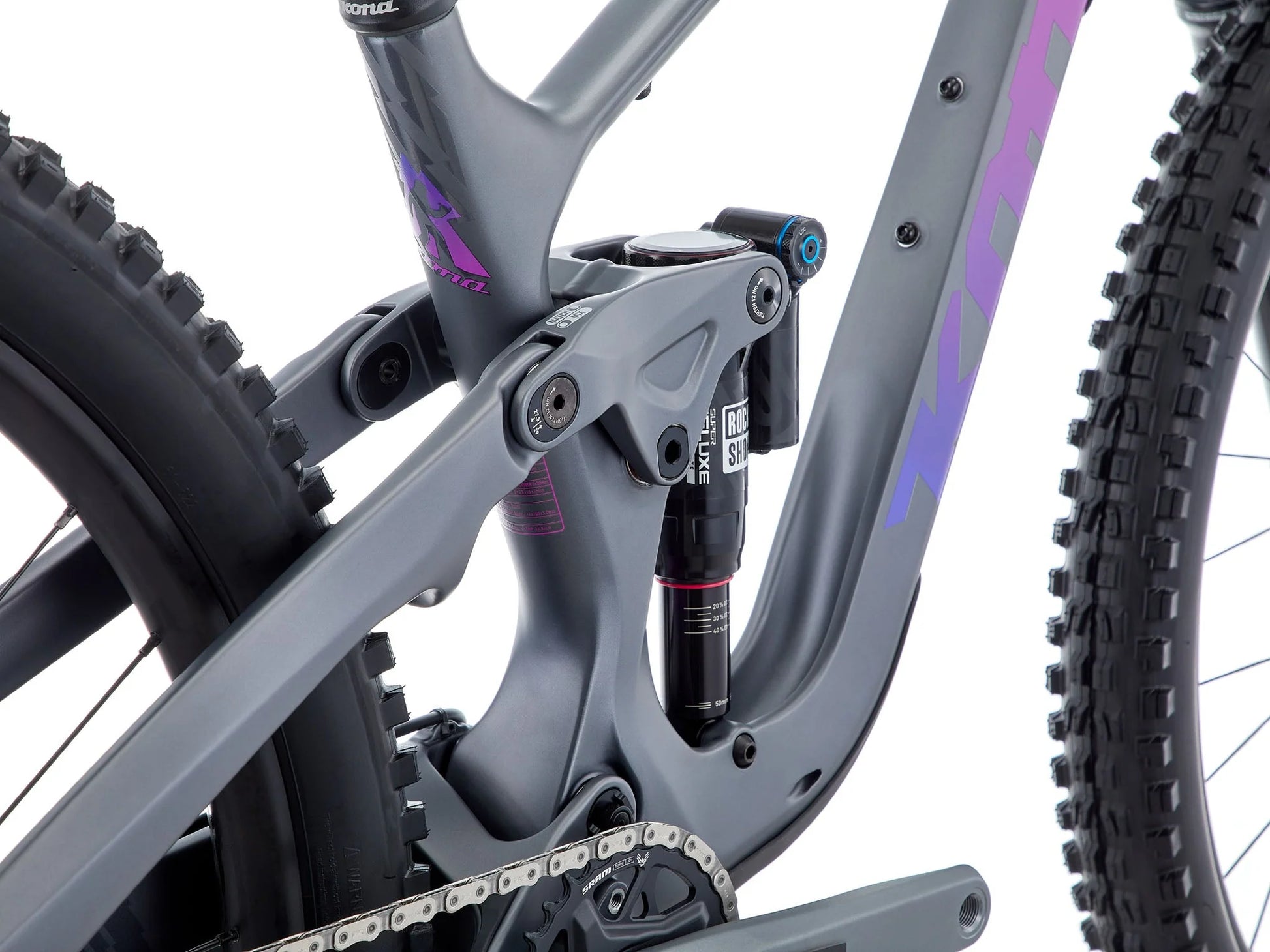 Close-up of a mountain bike with a focus on the suspension fork and chain.