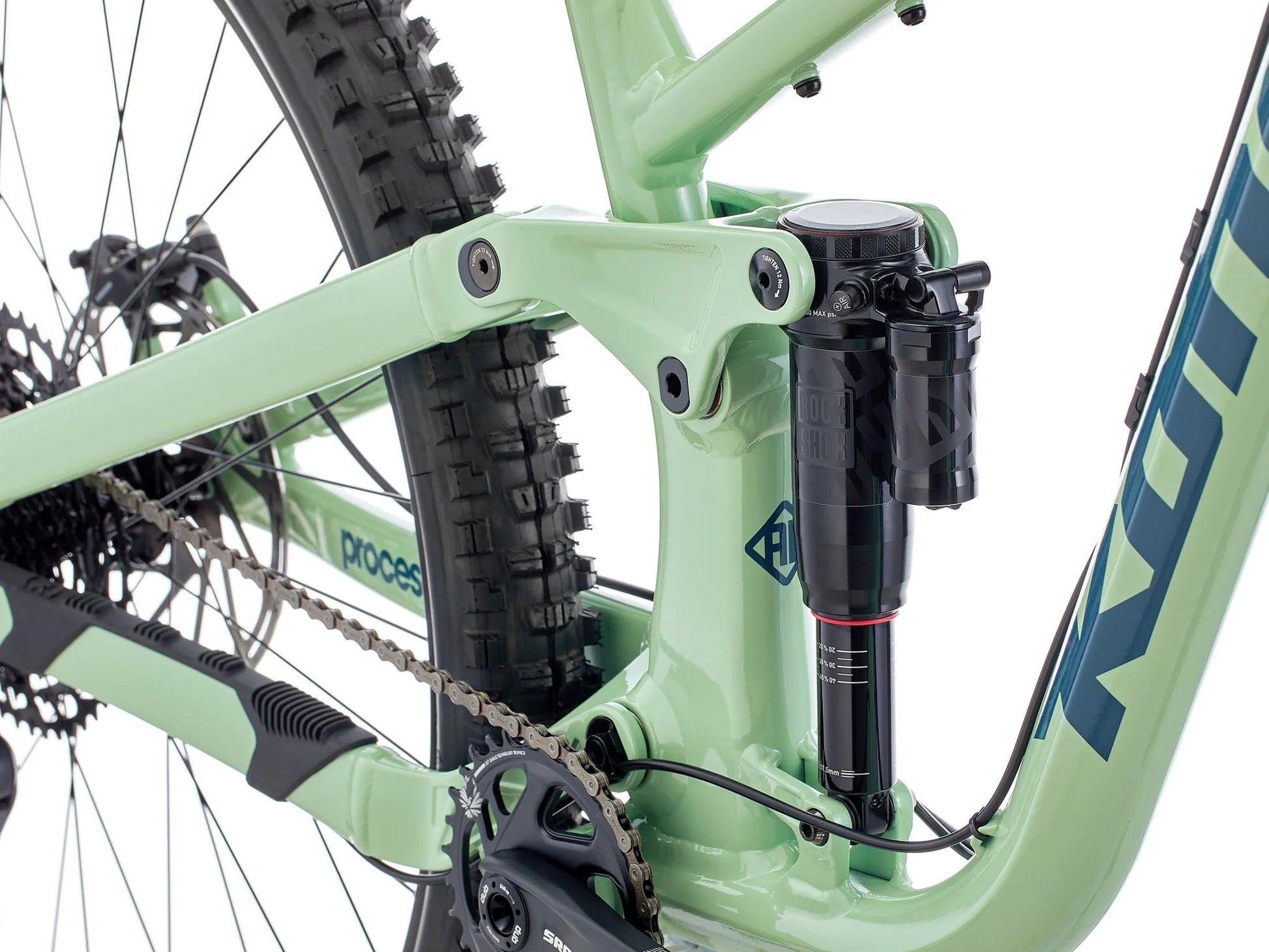 Close-up of a green bicycle with suspension fork on a white background